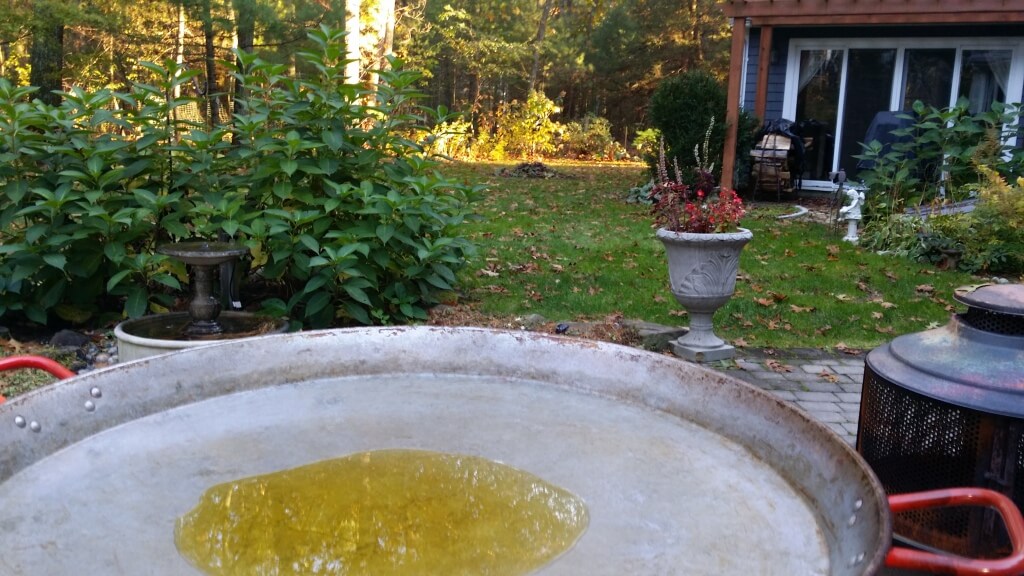 Outdoor cooking pan with oil in garden.