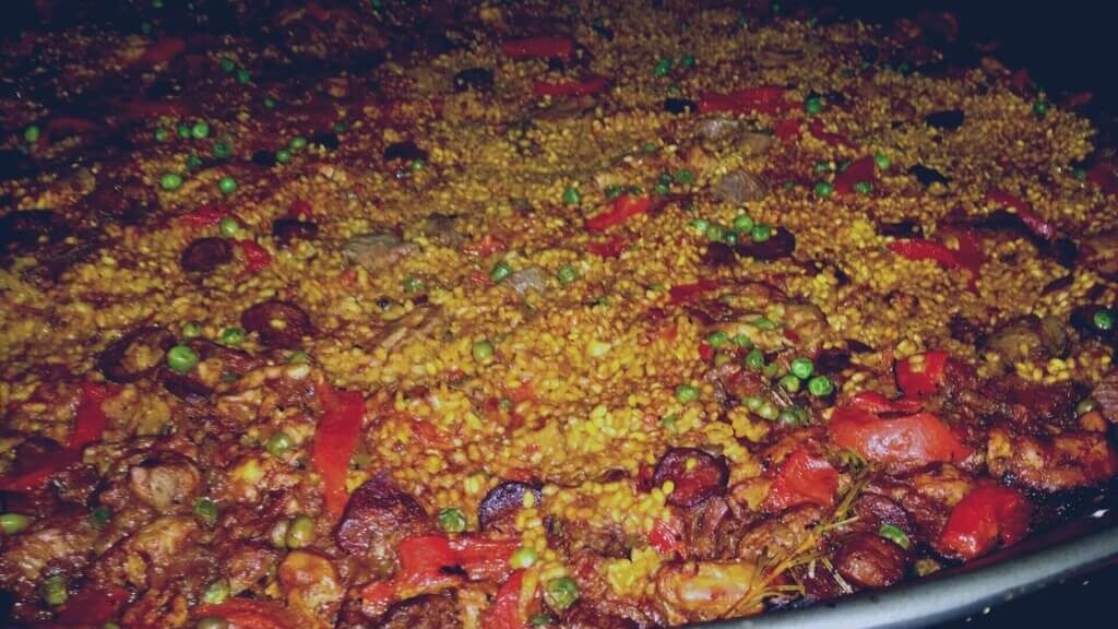 Traditional paella with vegetables and meat.