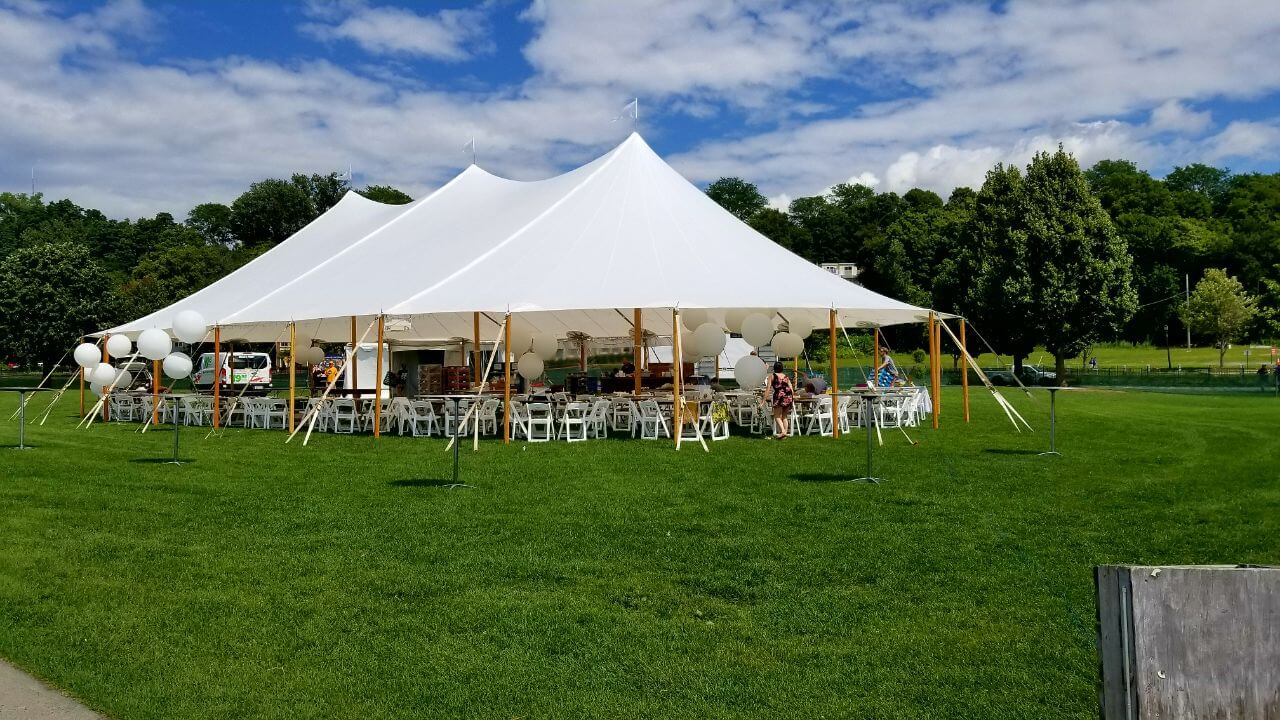 a big tent and chairs arranged on a ground
