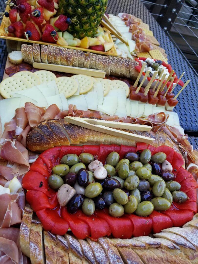 Olives, bread slices, cold cuts, and cheese