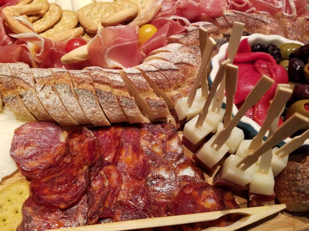 closeup of a plater of cold cuts and bread slices