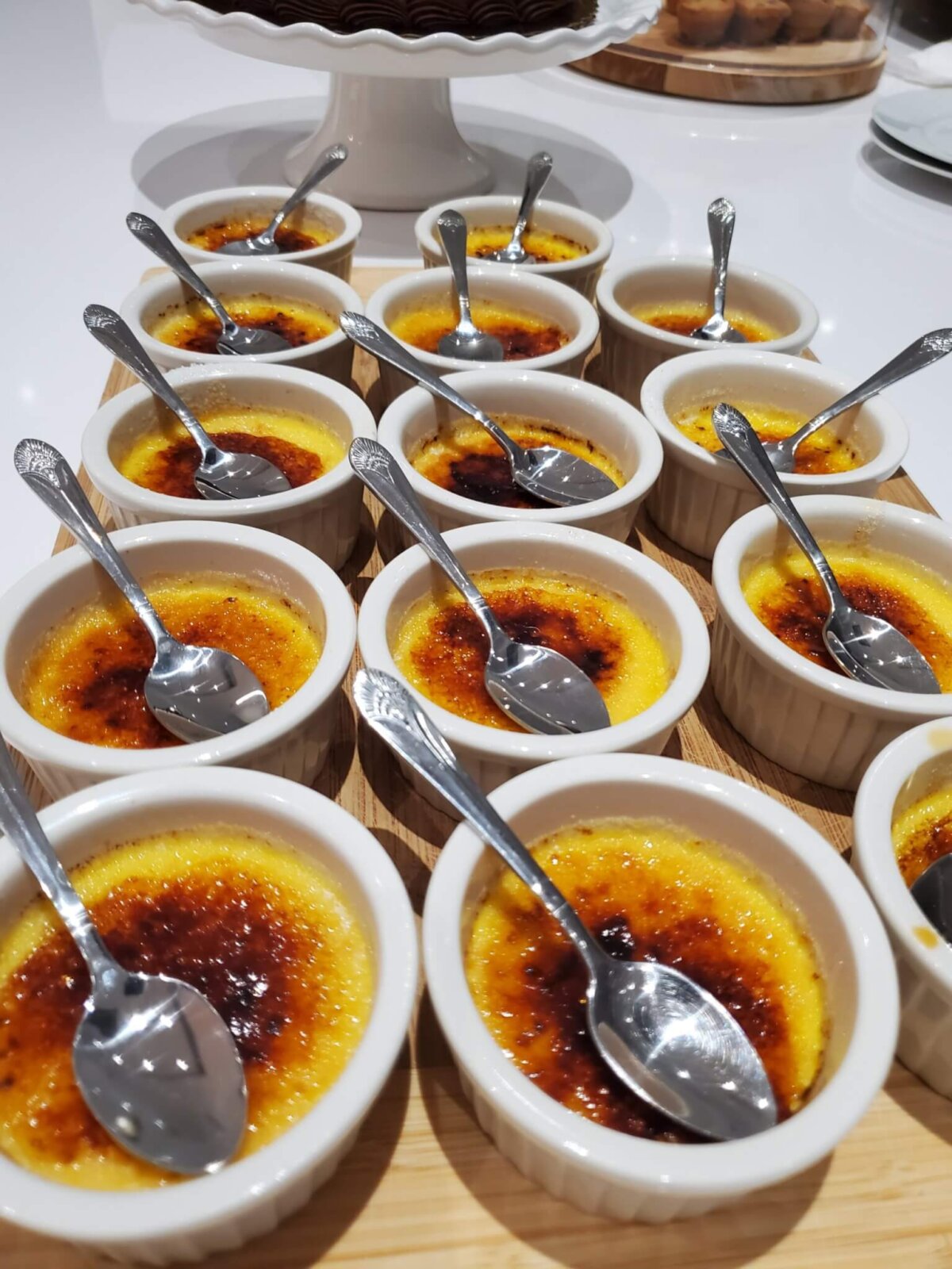 small bowls of Crème brûlée with steel spoons
