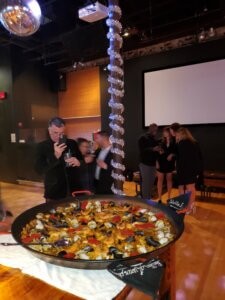 Paella dish at a festive indoor event.