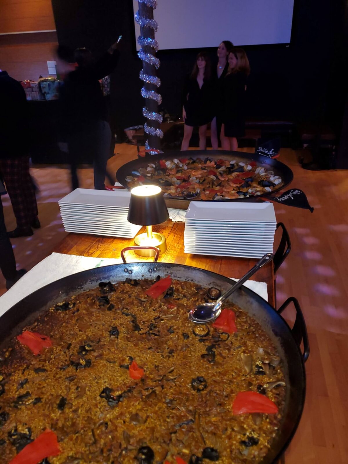 two huge pans of Paella on the table